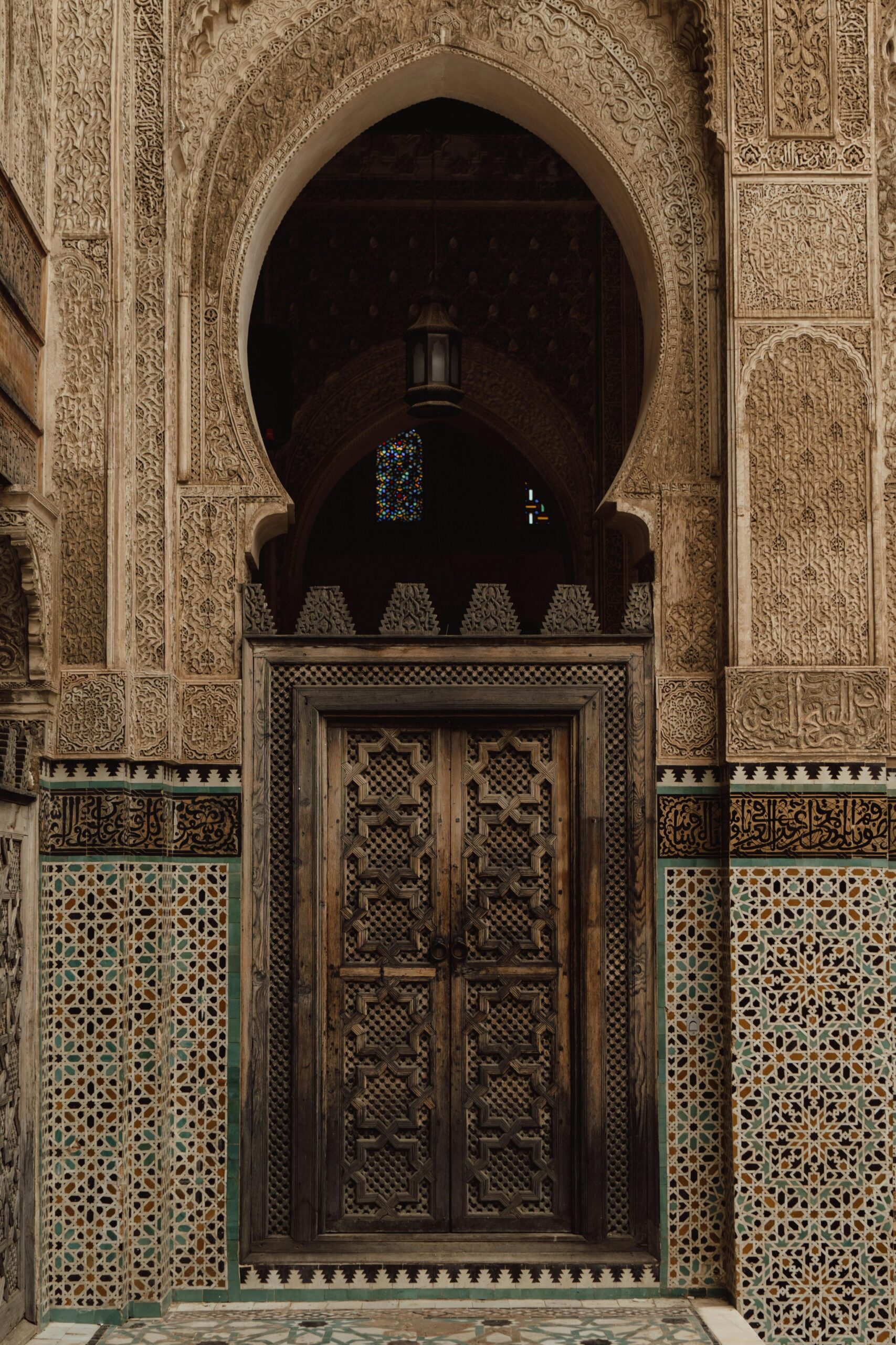 Beautiful Moroccan door with traditional Islamic patterns and mosaic tiles in Fes, Morocco.